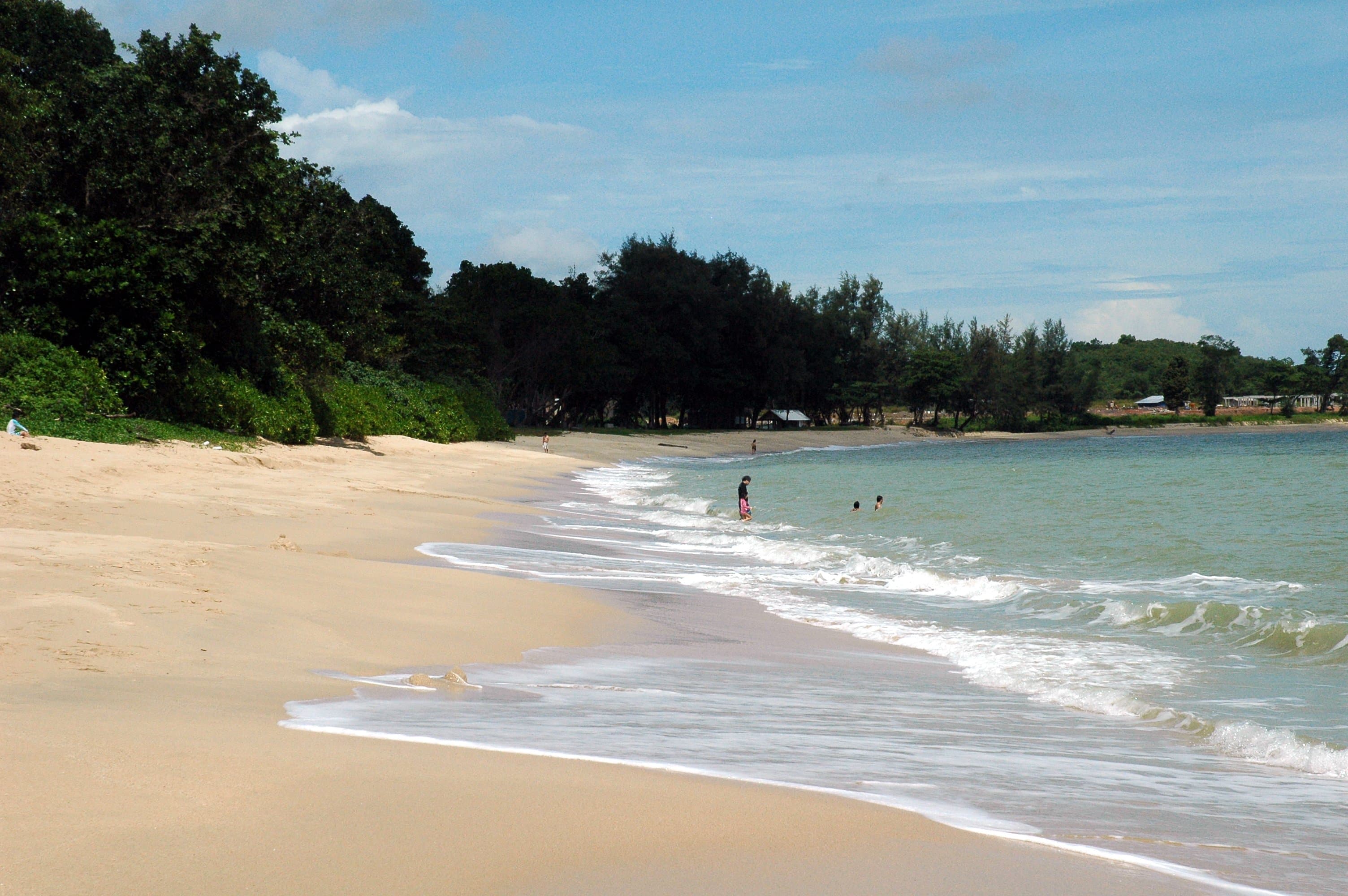 The wide golden-sand public beach at Desaru on the South China Sea